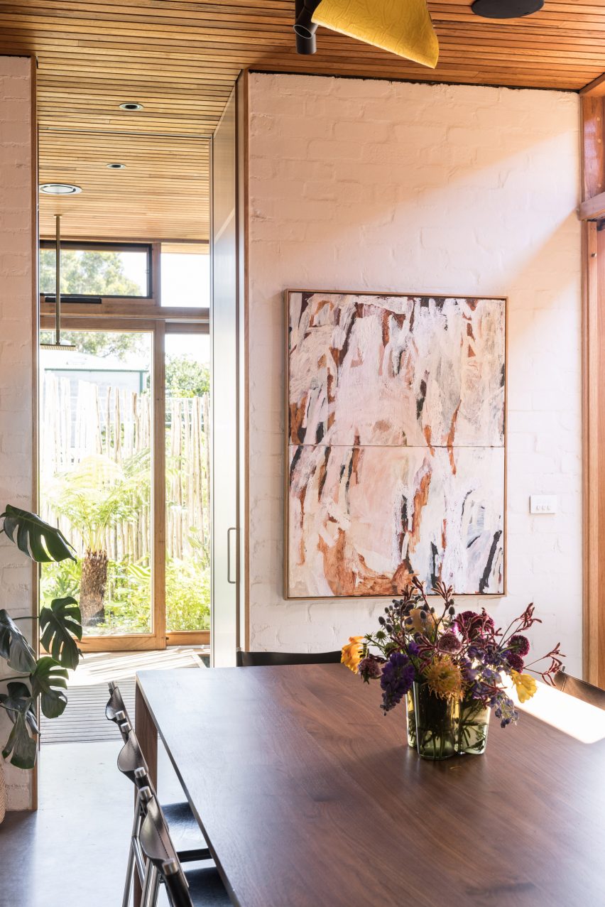 Dining room with a wood dining table and art on the walls