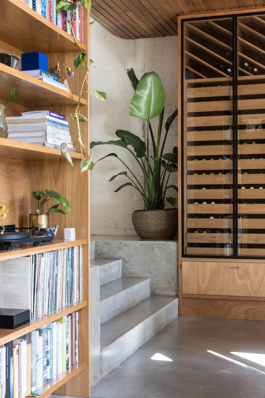 Room with concrete floors and steps and wooden storage