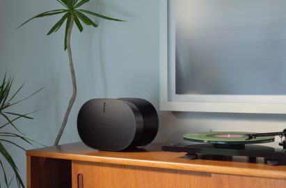 Sonos' Era 300 speaker in black sitting atop a credenza
