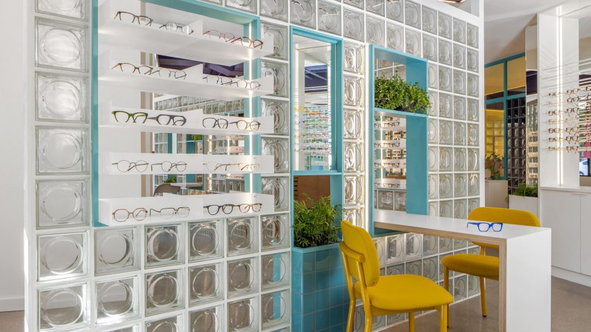 Glass brick wall with eyewear displayed in cutouts