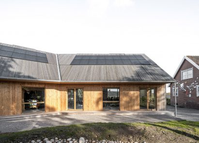 Wood-lined building with solar panels on the roof