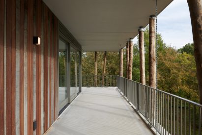 Balcony lined with tree trunks