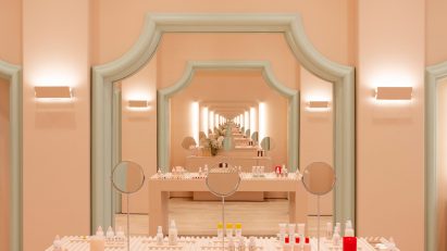 Infinite mirror reflections in pale pink Glossier store