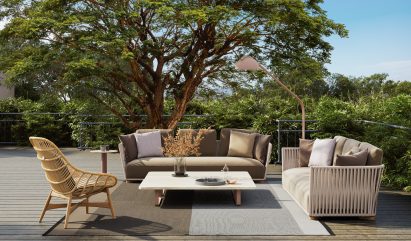 Chairs on terrace beside a tree