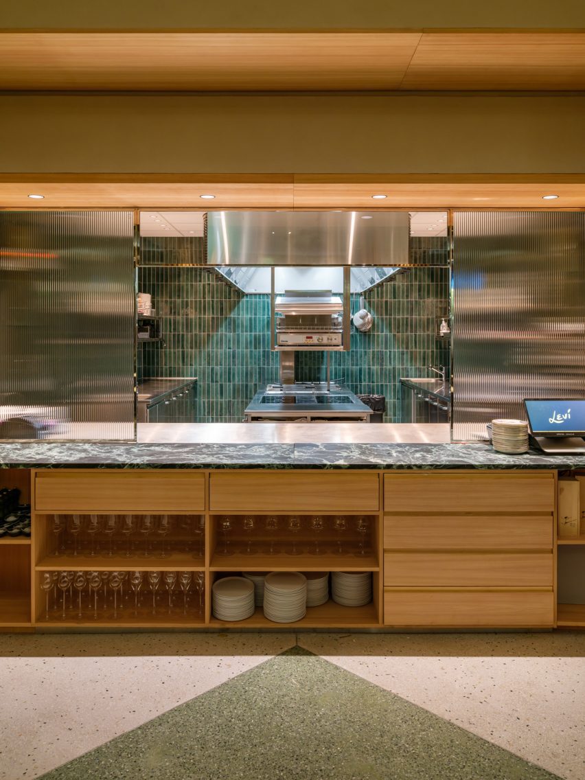 Restaurant kitchen with built-in wood furniture and terrazzo flooring