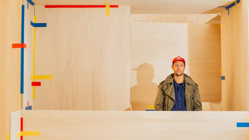 Jorge Penadés standing inside one of his Tape! pavilions made from plywood boards and tape