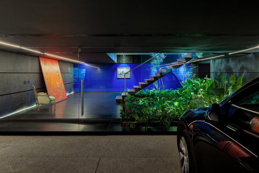 Stairs leading to a parking garage with granite floors and bright blue back wall