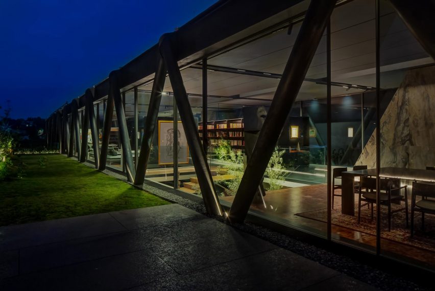 Exterior of a One-storey home with glazed walls revealing an open-plan living space