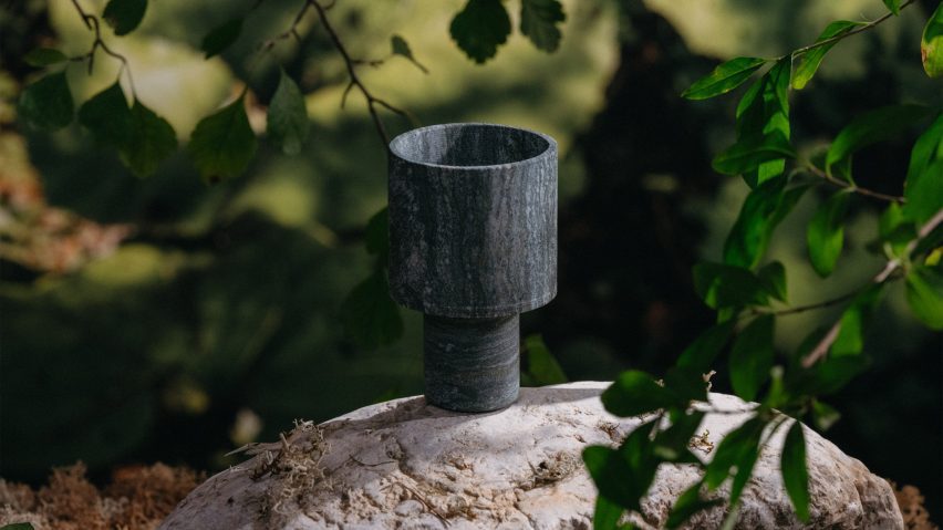 Stone cup place on a rock among trees