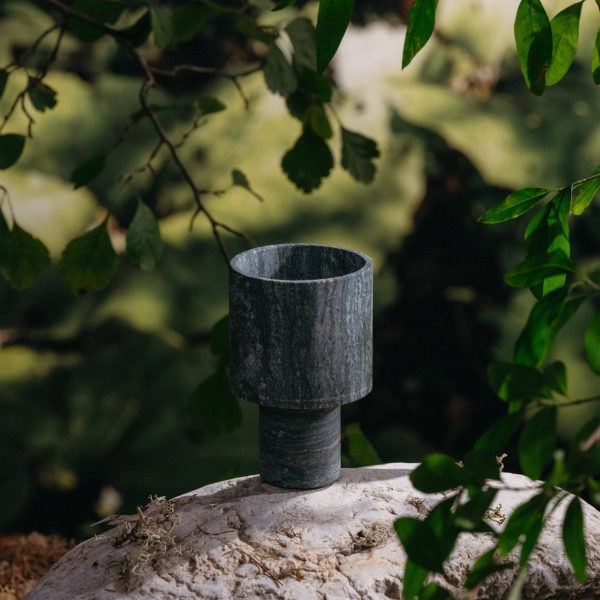 Stone cup place on a rock among trees