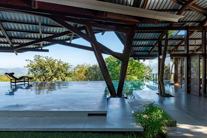 Outdoor terrace with a swimming pool and angular roof with a timber structure