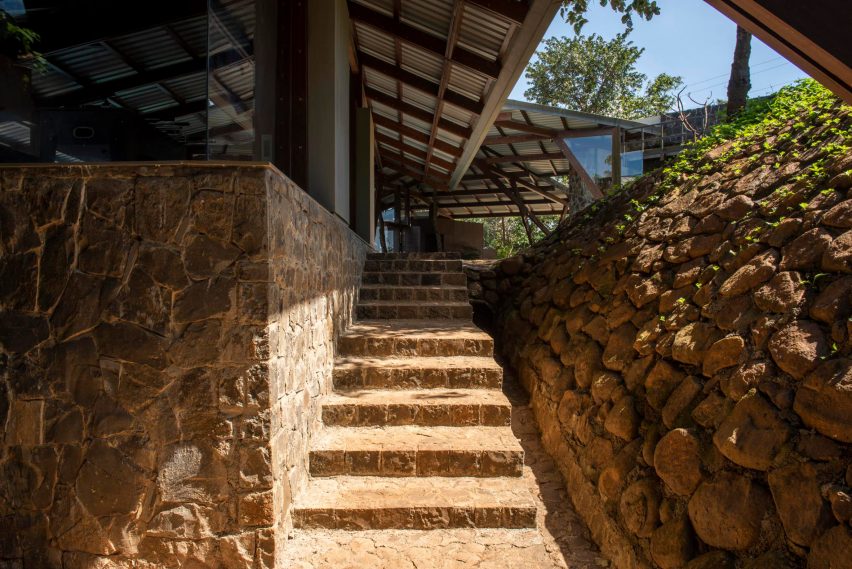 Sandy stone steps with a stone wall either side and a sloping roof overhead