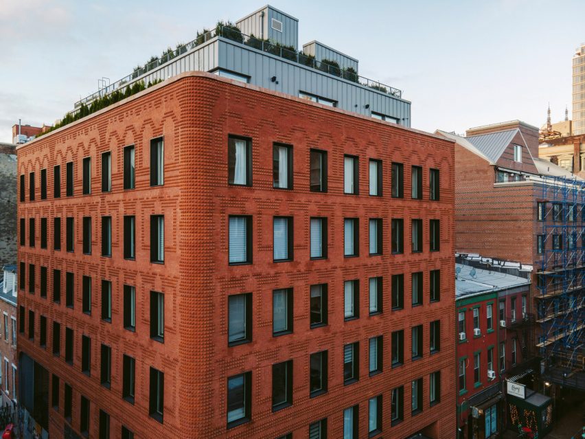Exterior of the red-brick Grand Mulburry building by Morris Adjmi with a textured facade
