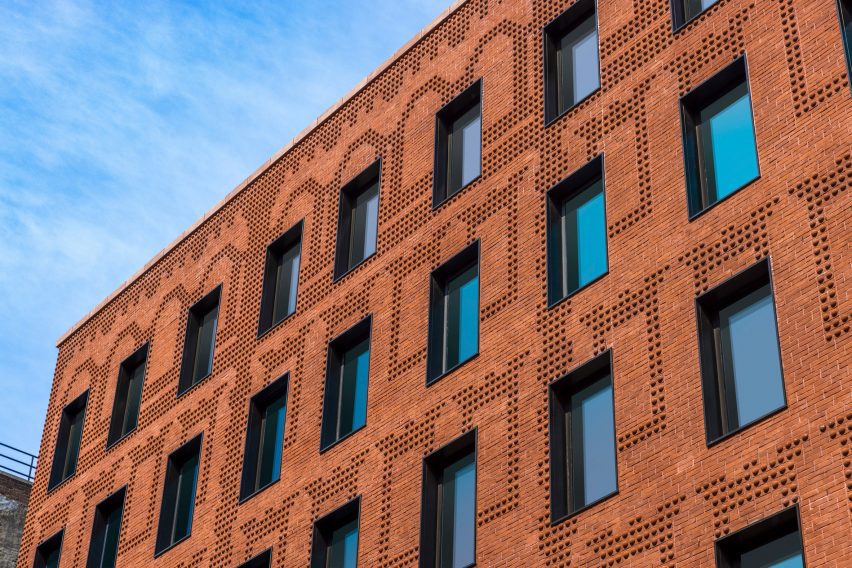 Exterior of the red-brick Grand Mulburry building by Morris Adjmi with a textured facade