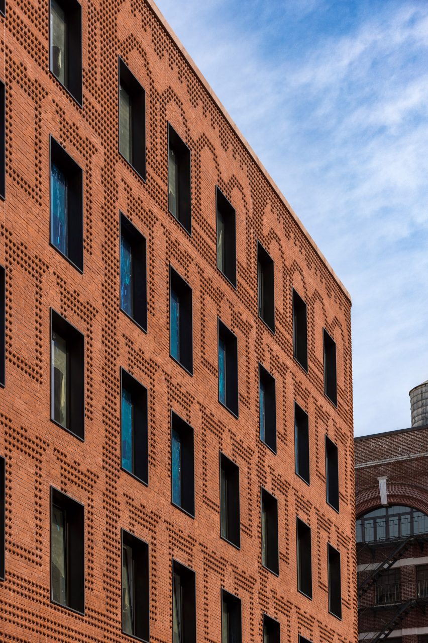 Exterior of the red-brick Grand Mulburry building by Morris Adjmi with a textured facade