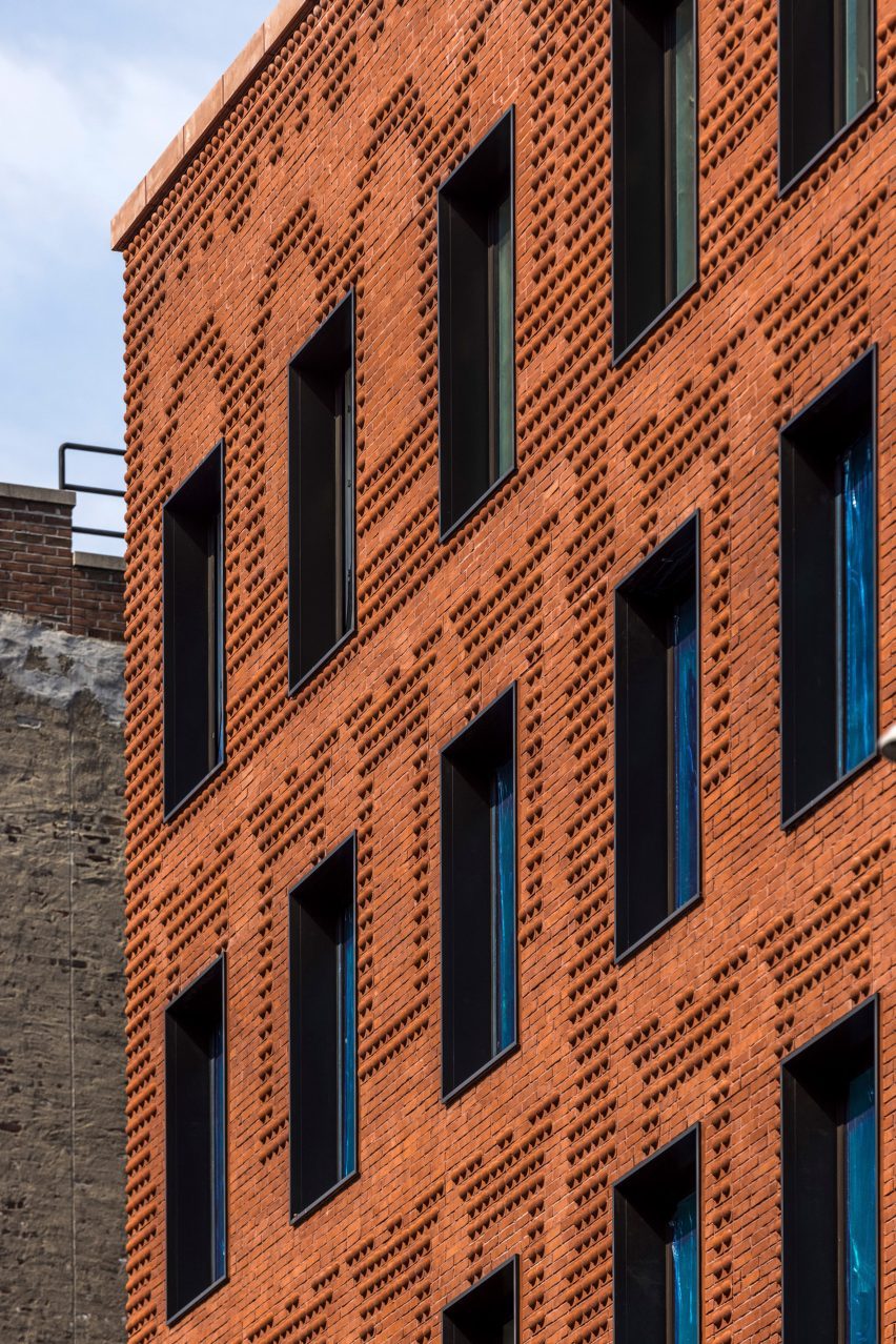 Exterior of the red-brick Grand Mulburry building by Morris Adjmi with a textured facade