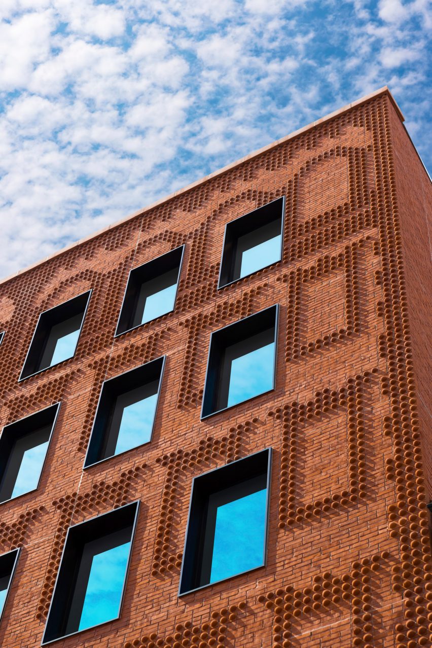 Exterior of the red-brick Grand Mulburry building by Morris Adjmi with a textured facade