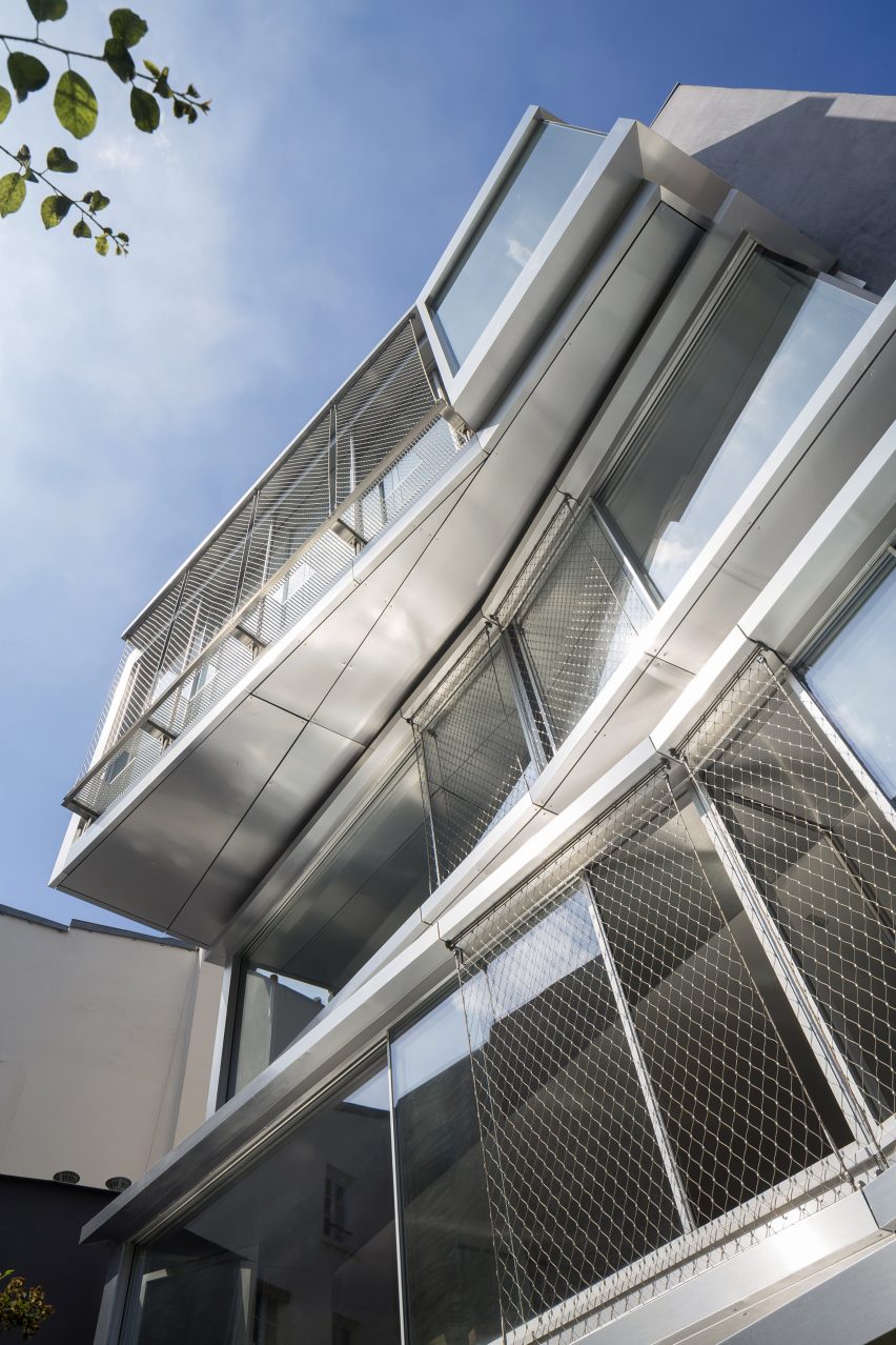 Multi-storey building with glazed facades and floor levels jutting at different angles