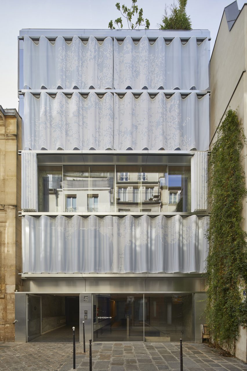 Multi-storey mixed-use building with curved moveable PVC curtain wall open on the third storey