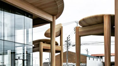 Nikken Sekkei shelters Japanese sweet company HQ with oversized table and chairs