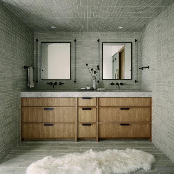 Quartzite vanity within bathroom with stone-hued tiles