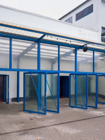 Blue-rimmed doors at ÅBEN brewery designed by Pihlmann Architects