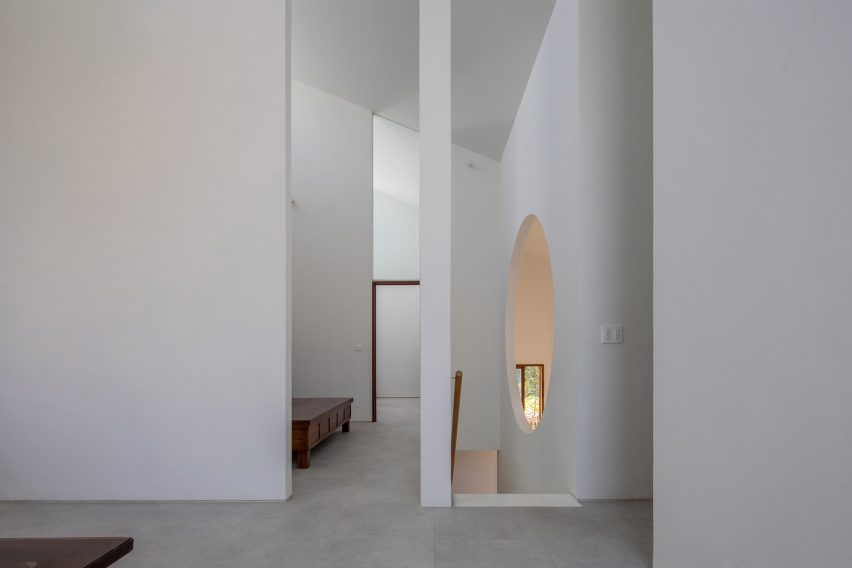 Interior space with concrete flooring, white walls and tall door openings
