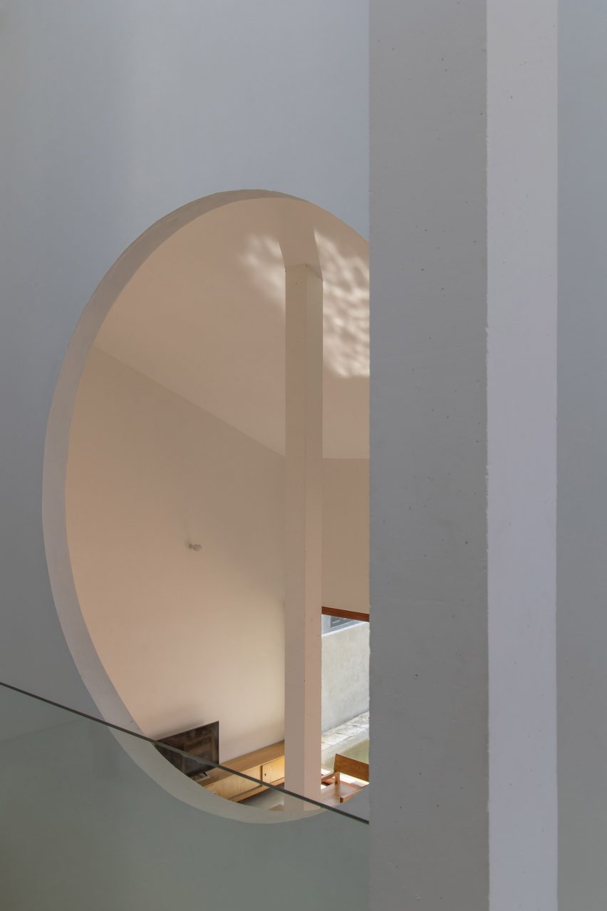 A circular window in a white wall