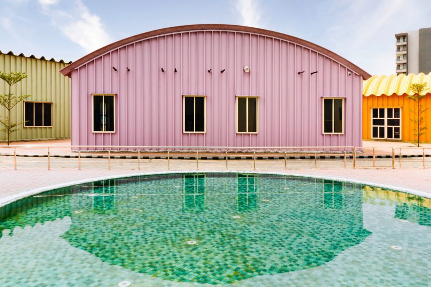 Pink steel shed in front of a swimming pool