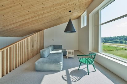 Living room with sloped wood-lined ceiling