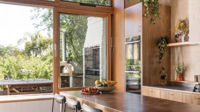 Kitchen with concrete flooring, wood ceiling and a large kitchen island with seating