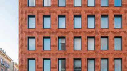 Exterior of the red-brick Grand Mulburry building by Morris Adjmi with a textured facade