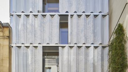 Top of a flat roof building with curved metal moveable curtain wall