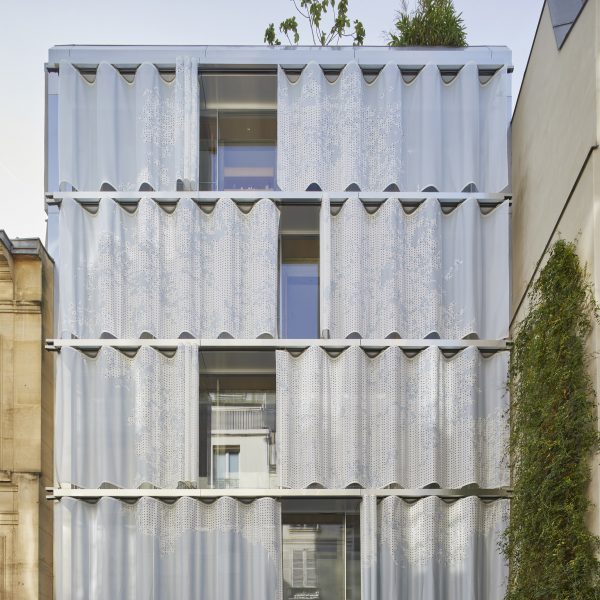 Top of a flat roof building with curved metal moveable curtain wall