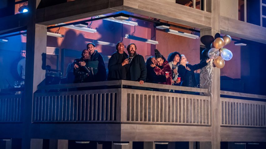 Actors standing on a balcony that replicates the Park Hill estate