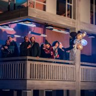 Actors standing on a balcony that replicates the Park Hill estate