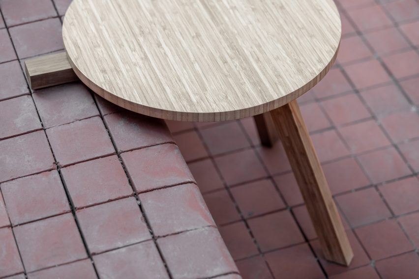 Table balanced on step with two front legs over edge