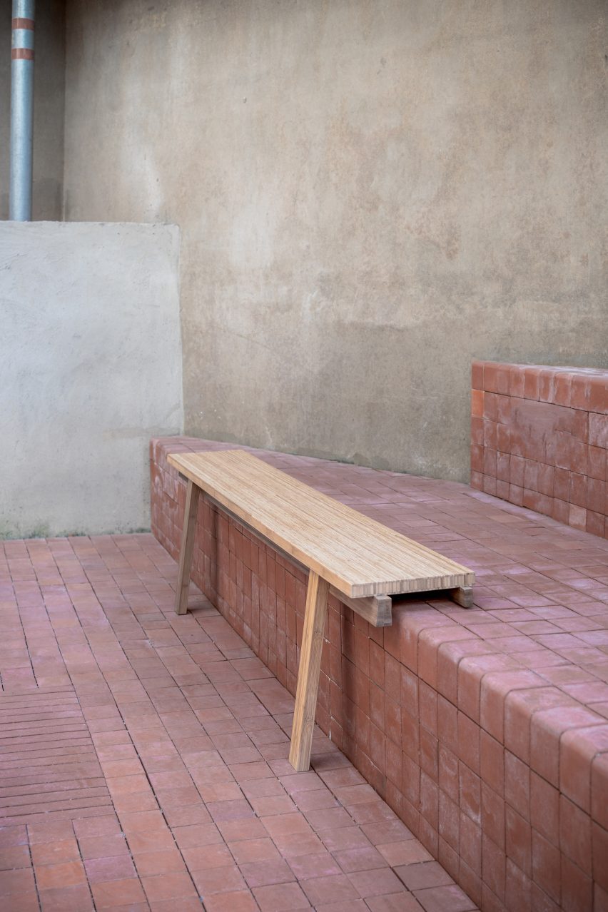 Bench balanced on step with two front legs over edge