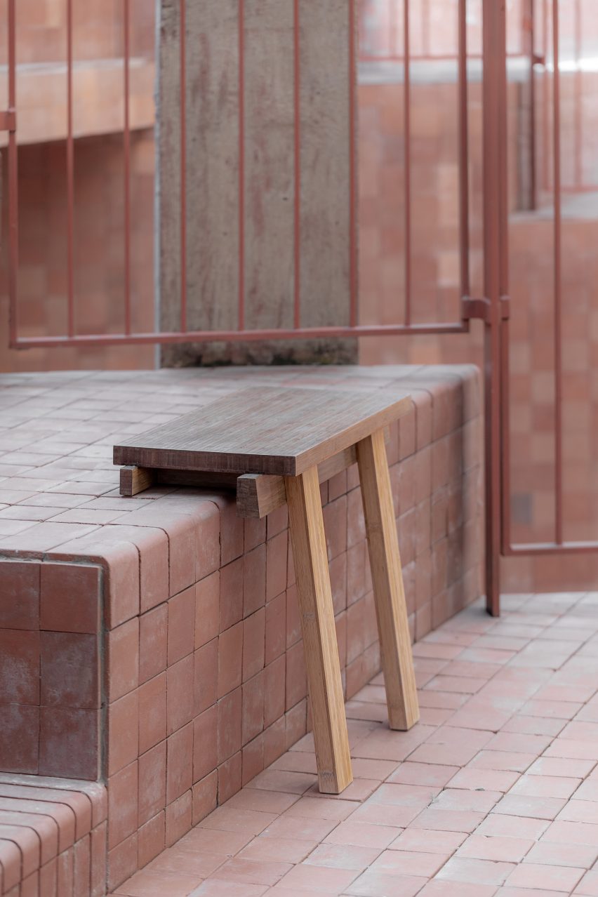 Bench balanced on step with two front legs over edge