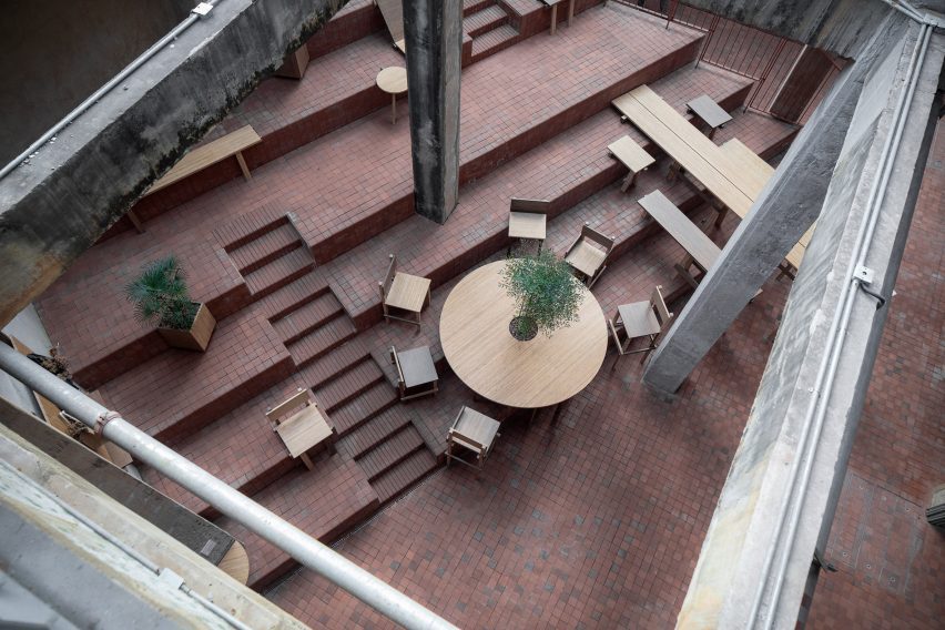Courtyard area with steps and wooden furniture