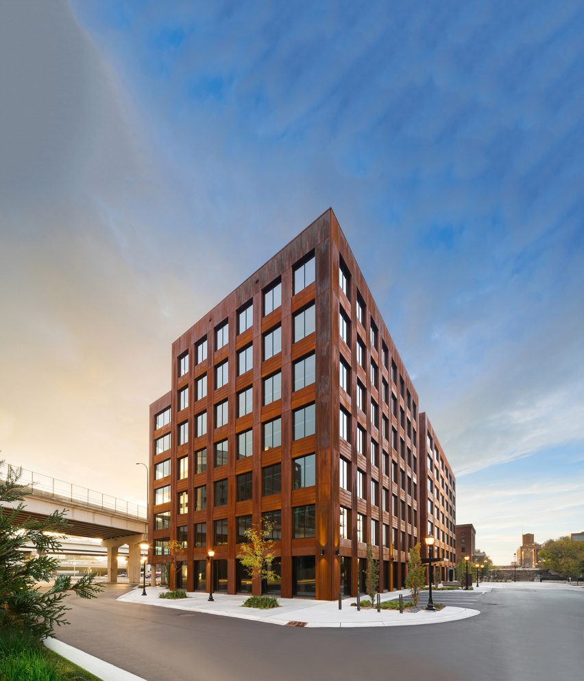 Exterior of the T3 office building with weathered steel cladding and grid windows