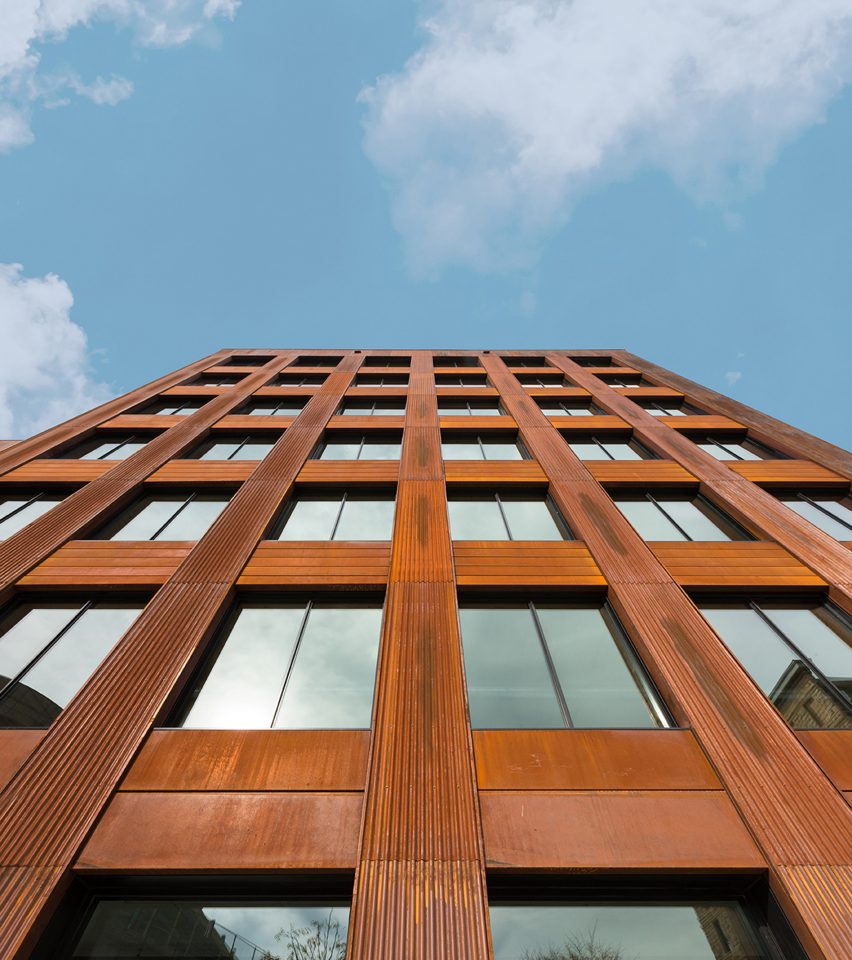 Exterior of a seven-storey office building clad in weathered steel