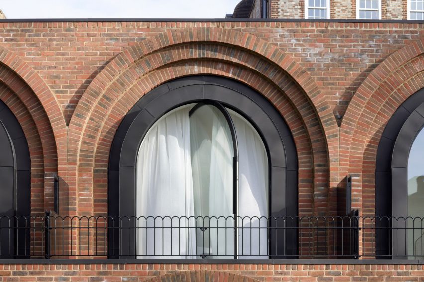 Arched window with pivoting glass at The Arches townhouses by The DHaus Company