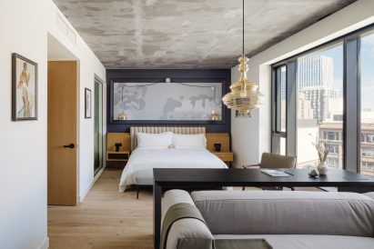 "Graffiti-tagged" headboard in sun-filled hotel bedroom