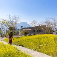 Woman walking past The Lodsi Community Project for Forest Essentials factory by Morphogenesis