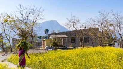Woman walking past The Lodsi Community Project for Forest Essentials factory by Morphogenesis