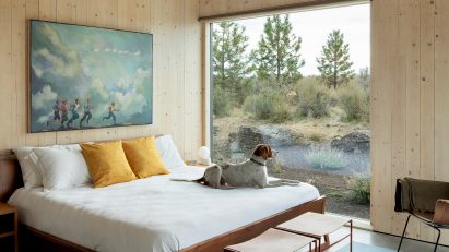 A bedroom interior with exposed timber