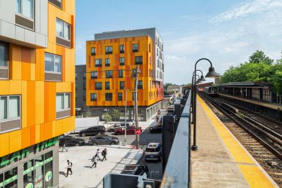 Two colourful social housing buildings with boxy windows