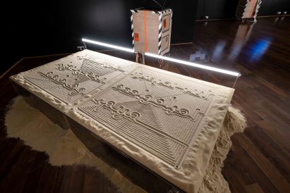Table covered in sand with symbols drawn into the sand