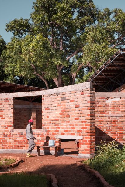 Person outside of Wayair School in Tanzania by Jeju Studio